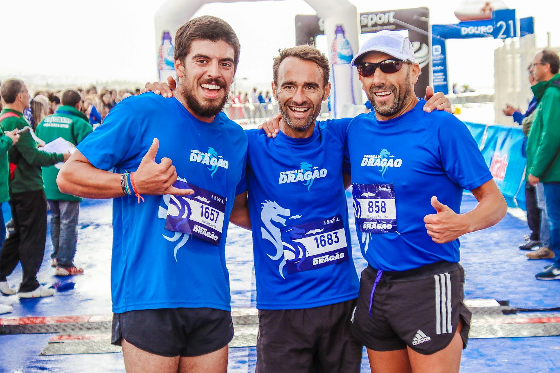 three men wearing blue t shirts
