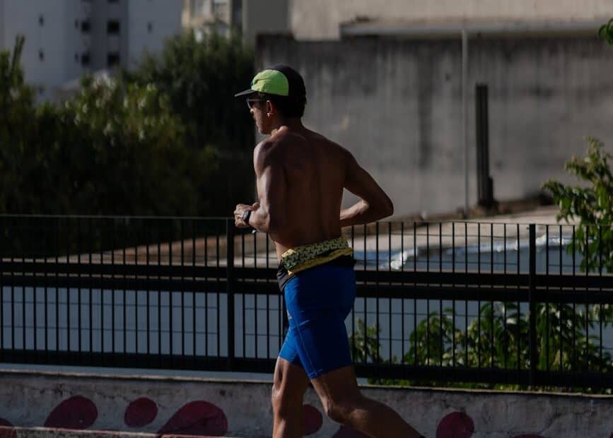 a man in a blue shirt is running on a street